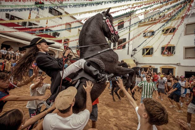 August 24, 2026, Ferreries, Menorca Balearic Islands, Spain: A caixer, or horse rider, rears his horse amid a cheering crowd during the traditional Jaleo at the Sant Bartomeu Festival in Ferreries. Ferreries Spain - ZUMAo105 20260824_fap_o105_026 Copyright: xMatthiasxOesterlex