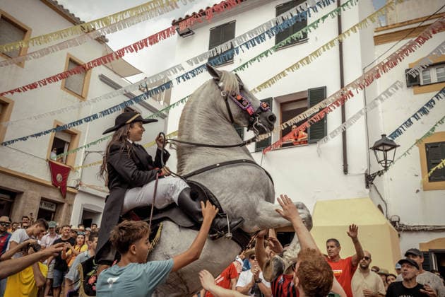 August 24, 2026, Ferreries, Menorca Balearic Islands, Spain: A caixer, or horse rider, rears his horse amid a cheering crowd during the traditional Jaleo at the Sant Bartomeu Festival in Ferreries. Ferreries Spain - ZUMAo105 20260824_fap_o105_029 Copyright: xMatthiasxOesterlex