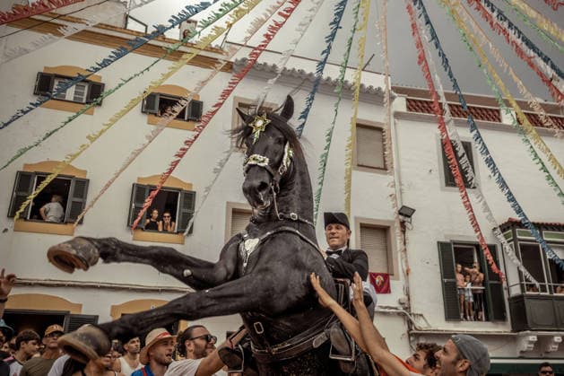 August 24, 2026, Ferreries, Menorca Balearic Islands, Spain: A caixer, or horse rider, rears his horse amid a cheering crowd during the traditional Jaleo at the Sant Bartomeu Festival in Ferreries. Ferreries Spain - ZUMAo105 20260824_fap_o105_031 Copyright: xMatthiasxOesterlex