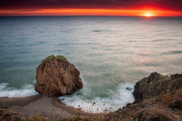 Long exposure of waves around a sea stack at sunset Sa Riera, Catalonia, Spain R_HEBU260812-2098538-01 ,model released, Symbolfoto ,property released