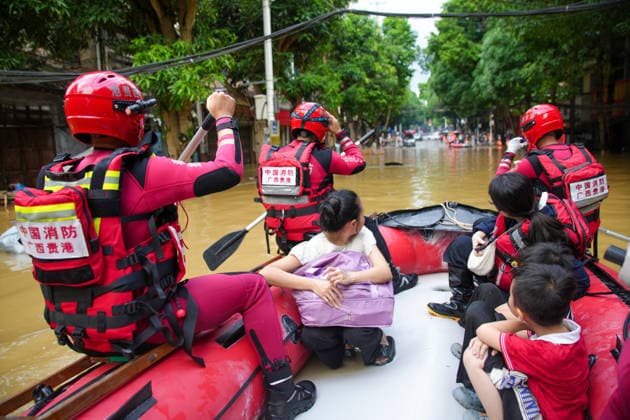 LONGZHOU, CHINA - AUGUST 24: Rescue workers evacuate residents trapped by floods caused by heavy rainfall from Typhoon Zitan and upstream water flow on August 24, 2026 in Longzhou, Guangxi Zhuang Autonomous Region of China. Water levels in the Zuo River section of Longzhou county rose continuously, submerging parts of the urban area, while local flood control departments monitored conditions and continued rescue operations.  Copyright: xChinaxNewsxServicex 111661931501