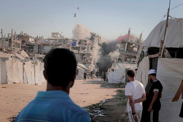 Israeli Strikes Beach Camp Gaza City Smoke rises from a strike as Palestinians stand beside tents near the Asqalan prayer hall in the Beach Camp in Gaza City, Gaza Strip, on August 24, 2026. Israeli warplanes struck the site following an evacuation warning to residents, completely destroying the Asqalan Prayer Hall and reportedly damaging nearby buildings. Gaza Gaza Strip Palestine Territories Copyright: xMohammedxMxSkaikx