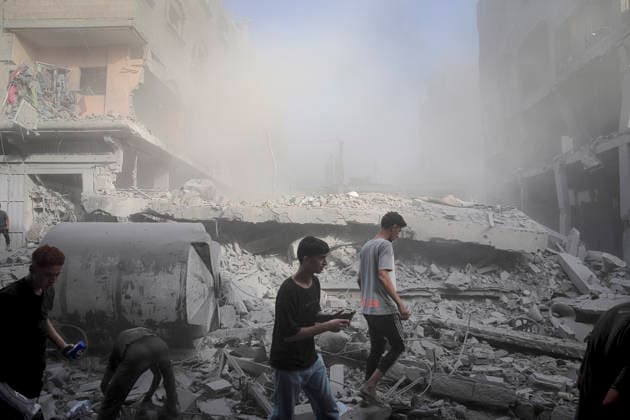 Israeli Strikes Beach Camp Gaza City Palestinians walk through dust in a rubble-filled street at the site of an Israeli strike in Gaza City, Gaza Strip, on August 24, 2026. Israeli warplanes struck the site following an evacuation warning to residents, completely destroying the Asqalan Prayer Hall and reportedly damaging nearby buildings. Gaza Gaza Strip Palestine Territories Copyright: xMohammedxMxSkaikx