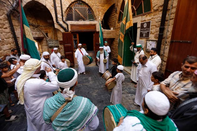 August 25, 2026, Saida, Saidon District, lebanon: Sufi devotees take part in a procession marking the birthday of Prophet Muhammad in the old city of Sidon, Lebanon. The procession began outside the RifaÃ¢â‚¬â ¢i Sufi lodge and moved through the historic streets accompanied by drums, chanting, swords and shields. Some devotees performed the traditional Ã¢â‚¬oeShishÃ¢â‚¬Â ritual, associated with certain RifaÃ¢â‚¬â ¢i Sufi communities, involving the piercing of the body with metal skewers during intense religious chanting. Residents distributed sweets and sprayed rose water as the procession passed. Saida lebanon - ZUMAb339 20260825_znp_b339_003 Copyright: xAbdulxKaderxAlxBayx