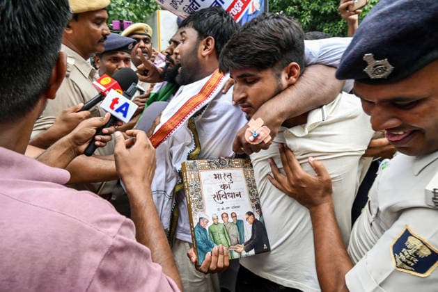 Protest Erupts in Bihar s Patna Patna, Aug 25 (ANI): A protester holds a copy of the Constitution during the protest, demanding the cancellation of the 70th BPSC examination, while condemning the alleged irregularities in the competitive examination, in Patna on Tuesday. Patna Bihar India Copyright: xANIx ANI_20260825097
