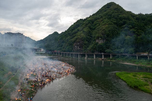 KAILI, CHINA - AUGUST 25: People burn paper offerings in designated areas to pay tribute to their departed loved ones ahead of the Zhongyuan Festival (Ghost Festival) on August 25, 2026 in Kaili, Guizhou Province of China. The Ghost Festival, also known as Zhongyuan Festival, is a traditional festival for paying respect to the dead.  Copyright: xVCGx 111662157008