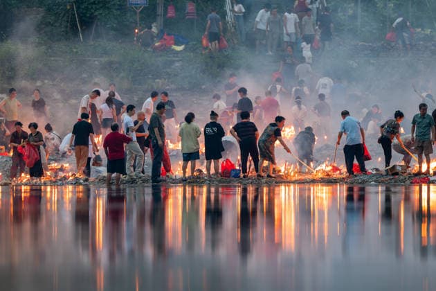 KAILI, CHINA - AUGUST 25: People burn paper offerings in designated areas to pay tribute to their departed loved ones ahead of the Zhongyuan Festival (Ghost Festival) on August 25, 2026 in Kaili, Guizhou Province of China. The Ghost Festival, also known as Zhongyuan Festival, is a traditional festival for paying respect to the dead.  Copyright: xVCGx 111662157009