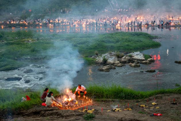 KAILI, CHINA - AUGUST 25: People burn paper offerings in designated areas to pay tribute to their departed loved ones ahead of the Zhongyuan Festival (Ghost Festival) on August 25, 2026 in Kaili, Guizhou Province of China. The Ghost Festival, also known as Zhongyuan Festival, is a traditional festival for paying respect to the dead.  Copyright: xVCGx 111662157005