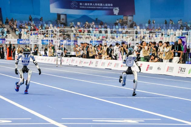 BEIJING, CHINA - AUGUST 25: Robots compete in the 100-meter small group race during day three of the Second World Humanoid Robot Games on day 4 of the 2nd World Humanoid Robot Games at National Speed Skating Oval on August 25, 2026 in Beijing, China.  Copyright: xVCGx 111662143564