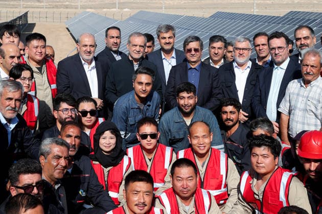 August 25, 2026, Tehran, Iran: Iranian President Masoud Pezeshkian poses with officials and people wearing red safety vests in front of rows of solar panels during the inauguration of two solar power plants in Tehran Province, Iran, on August 25, 2026. The projects comprise the 63-megawatt Ghaed Shahid solar power plant and the 32-megawatt Shohadaye Lamerd solar power plant, according to the Iranian presidentÃ¢â‚¬â ¢s office. Tehran Iran - ZUMAi98_ 20260825_zih_i98_012 Copyright: xIranianxPresidencyx