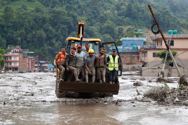 August 26, 2026, Nuwakot, Nepal: Security personnel rescue people in a dozer from buildings and infrastructure that were damaged along the swollen Trishuli River following a massive flash flood triggered by an avalanche of ice and rock in the upper Lhende River on the Tibetan side, in Nuwakot district, Nepal, on Wednesday, August 26, 2026. The sudden flood swept through communities along the Bhote Koshi and Trishuli river systems, destroying homes, roads and bridges and leaving widespread devastation downstream. Nuwakot Nepal  - ZUMAg200 20260826_zap_g200_015 Copyright: xSkandaxGautamx