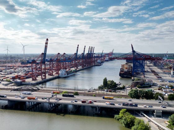 Container ships are docked at the 1,400-meter-long pier of the Burchardkai Container Terminal, which belongs to HHLA in the Port of Hamburg; to the left is the Eurogate Container Terminal; in the foreground are the Port of Rugenberg, the A7 highway, and the Waltershofer Bridges, Waltershofer Harbor, Hamburg, August 26, 2026