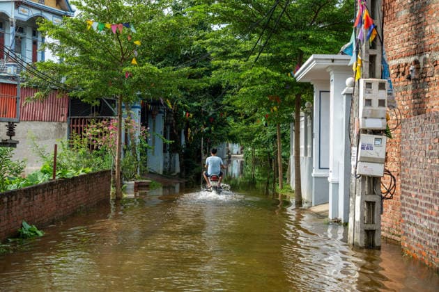 Flooding disrupts life along Vietnam’s riverbanks AN LAC, VIETNAM - AUGUST 26: A person drives a motorcycle through floodwaters surrounding villages along the Cau River after it overflowed following heavy rainfall in An Lac, northern Vietnam on August 26, 2026. Many residents in affected areas have been evacuated as rising water levels inundated homes, roads and agricultural land, leaving some communities partially or completely submerged. Magdalena Chodownik Anadolu An Lac Vietnam. Editorial use only. Please get in touch for any other usage.  Copyright: x2026xAnadoluxMagdalenaxChodownikx