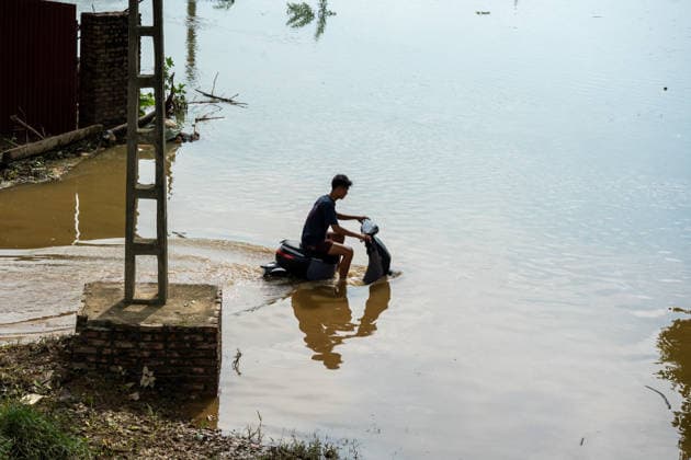 Flooding disrupts life along Vietnam’s riverbanks AN LAC, VIETNAM - AUGUST 26: A person drives a motorcycle through floodwaters surrounding villages along the Cau River after it overflowed following heavy rainfall in An Lac, northern Vietnam on August 26, 2026. Many residents in affected areas have been evacuated as rising water levels inundated homes, roads and agricultural land, leaving some communities partially or completely submerged. Magdalena Chodownik Anadolu An Lac Vietnam. Editorial use only. Please get in touch for any other usage.  Copyright: x2026xAnadoluxMagdalenaxChodownikx