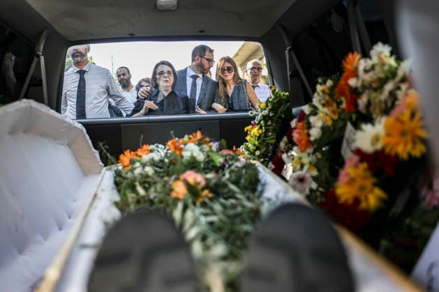 Palestinians Mourn Artist Sliman Mansour The flower-covered coffin of renowned Palestinian artist Sliman Mansour is seen inside a hearse as mourners stand outside in Birzeit, north of Ramallah, in the occupied West Bank, on August 26, 2026. Mansour, one of the most prominent figures in contemporary Palestinian visual art, died on August 24 at the age of 79 and was known for works depicting Palestinian landscapes, heritage and life under Israeli occupation, including his 1973 painting Camel of Hardships.? Ramallah West Bank Palestinian Territories Copyright: xMohammadxNazzalx