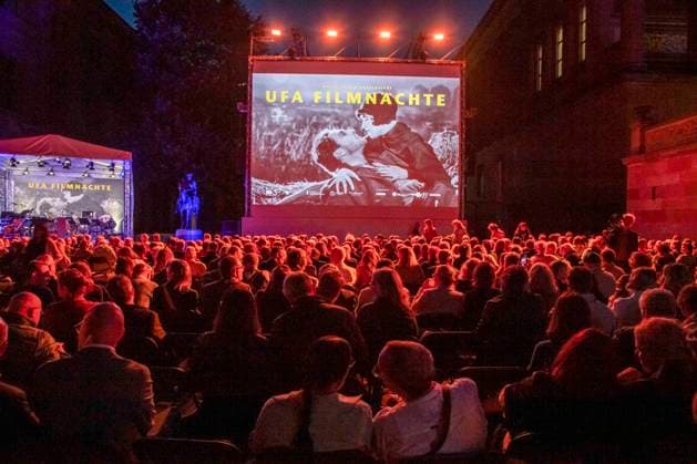 ABB FILM NIGHT Overview with movie screen; guests and visitors at the opening reception for the 2026 UFA Film Nights on the rooftop terrace of Bertelsmann Repraesentanz on August 26, 2026, in Berlin, Germany