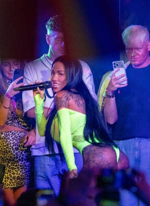 Kate Price at Manchester Village Pride 2026 in Manchester, UK - 28 Aug 2026 Model turned singer, Katie Price commands the stage in a vibrant yellow bodysuit during a provocative performance at Via Manchester on Canal Street for the inaugural Manchester Village Pride 2026. The reality TV icon teased the packed crowd, playing with her hair and striking dramatic poses in the sweltering heat of the venue, pausing occasionally for drags from her vape and sips of her drink. Delivering an interactive set, Price invited excited members of the audience onto the stage to sing along with her, leaving several fans visibly emotional as they shared the microphone with the star. Manchester United Kingdom Copyright: xGaryxRobertsx xSOPAxImagesx GROBERTS-16