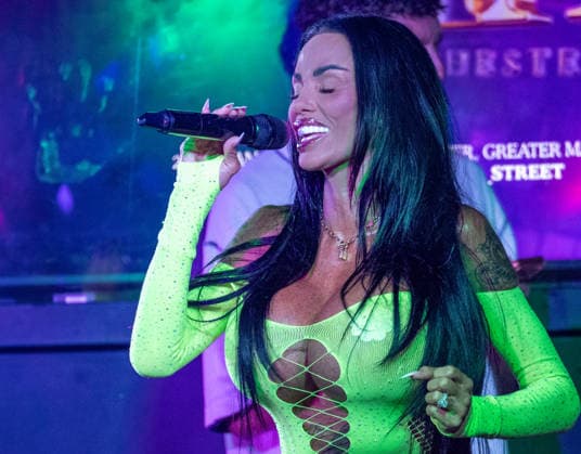 Kate Price at Manchester Village Pride 2026 in Manchester, UK - 28 Aug 2026 Model turned singer, Katie Price commands the stage in a vibrant yellow bodysuit during a provocative performance at Via Manchester on Canal Street for the inaugural Manchester Village Pride 2026. The reality TV icon teased the packed crowd, playing with her hair and striking dramatic poses in the sweltering heat of the venue, pausing occasionally for drags from her vape and sips of her drink. Delivering an interactive set, Price invited excited members of the audience onto the stage to sing along with her, leaving several fans visibly emotional as they shared the microphone with the star. Manchester United Kingdom Copyright: xGaryxRobertsx xSOPAxImagesx GROBERTS-42