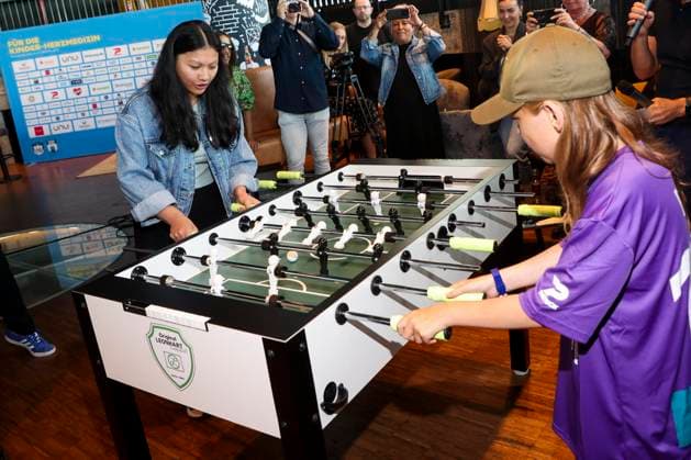ABB HERZKICKEN: Emil, Linh Tran, at the foosball table during a press conference for the Kicken mit Herz charity event at Restaurant Karo Paul in the Bunker at Feldstrasse 27, AUGUST 2026, in Hamburg, Germany