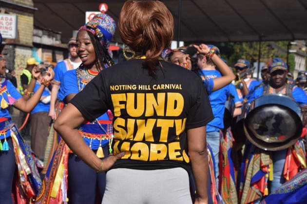 August 30, 2026, London, England, United Kingdom: A participant wears a Fund Sixty More t-shirt at the start of the Notting Hill Carnival parade on Family Day. This year celebrates the 60th anniversary of EuropeÃ¢â‚¬â ¢s biggest street festival. London United Kingdom - ZUMAv130 20260830_zip_v130_008 Copyright: xVukxValcicx
