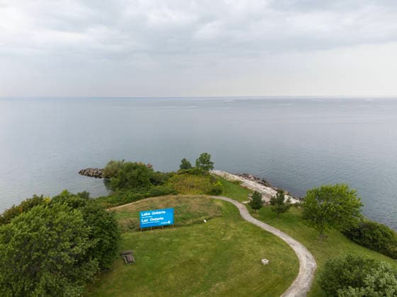 (260830) -- HAMILTON, Aug. 30, 2026 -- An aerial drone photo taken on Aug. 30, 2026 shows an English-French bilingual sign reading Lake Ontario Now and Always at a lakeside conservation area in Hamilton, Ontario, Canada. Canadian Prime Minister Mark Carney said Thursday that the name Lake Ontario carries a long history and that Canadians will always use this name regardless of external changes. The Canadian prime minister made the remarks after U.S. President Donald Trump signed an executive order earlier on Thursday, directing the Department of the Interior to rename the lake Lake America, as trade tensions between the United States and Canada have been escalating. (Photo by Xinhua) CANADA-ONTARIO-HAMILTON-LAKE ONTARIO-NAME ZouxZ 