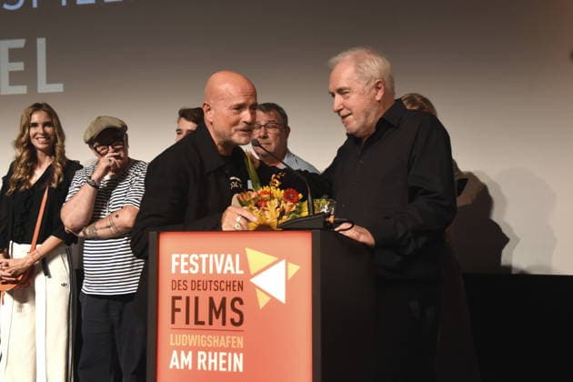Christian Berkel, actor, winner of the 2026 Festival Award for Acting; Dr. Michael Goetz, laudatory speaker; Ludwigshafen Festival Director; August 30, 2026, on the banks of the Rhine; 22nd German Film Festival 2026; Photo: Ludwigshafen