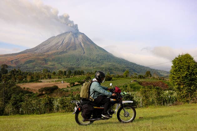 Volcanic activity continues at Mount Sinabung following massive eruption KARO, INDONESIA - SEPTEMBER 1: A man rides his motorbike as volcanic activity continues at Mount Sinabung as it spews volcanic material in Karo Regency, North Sumatra, Indonesia, on September 1, 2026. Following a massive eruption on August 31 that sent a thick column of volcanic ash approximately 3,500 meters (3.5 kilometers) above its summit, the ongoing ashfall and atmospheric disruptions led to the cancellation of 21 flights to and from Kualanamu International Airport. Risky Cahyadi Anadolu Karo Indonesia. Editorial use only. Please get in touch for any other usage.  Copyright: x2026xAnadoluxRiskyxCahyadix