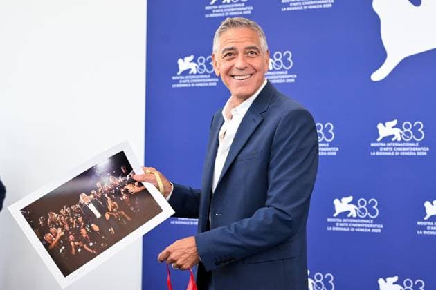 September 2, 2026, Venice, Rome, Italy: George Clooney receives a photo from Andrea AvezÃ¢oeÃ¢¢Â£ as a sign of friendship for his availability on the part of photographers, he is named honorary photographer, during the photocall for the Golden Lion for Lifetime Achievement at the 83rd Venice Film Festival. Venice, 02 09 2026 Venice Italy  - ZUMAa289 20260902_zia_a289_062 Copyright: xMariaxLauraxAntonellix xAgfx