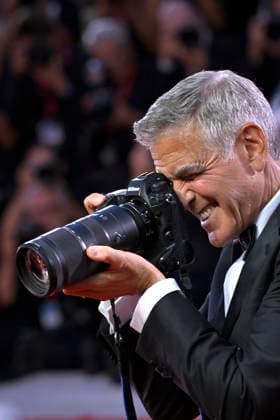 George Clooney holds a camera when arriving on the red carpet after receiving the Golden Lion for Lifetime Achievement Award during the Opening Ceremony the 83rd Venice International Film Festival at Sala Grande on September 2, 2026 in Venice, Italy.  VFF20260902867 RoccoxSpaziani