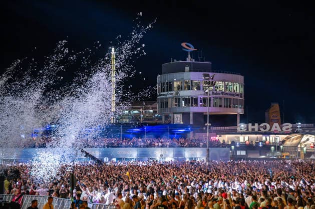 Overview of the large crowd of festivalgoers at the Dimitri Vegas & Like Mike performance at the Glücksgefühle Festival at the Hockenheimring in Hockenheim, Baden-Württemberg, Germany