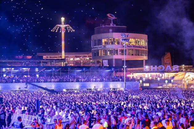 Overview of the large crowd of festivalgoers at Dimitri Vegas Like Mike s performance at the Glücksgefühle Festival at the Hockenheimring in Hockenheim, Baden-Württemberg, Germany