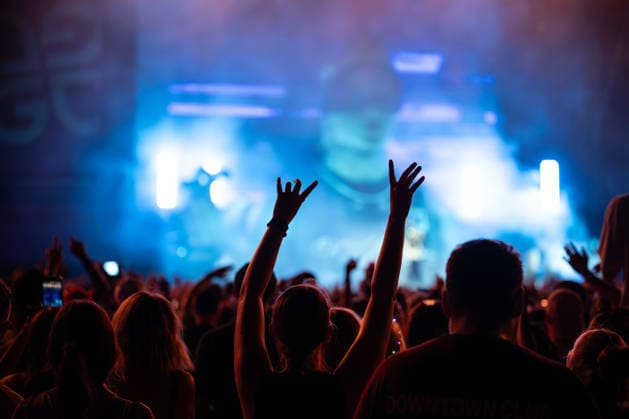 A festivalgoer waves her arms during Ski Aggu s performance at the Glücksgefühle Festival at the Hockenheimring in Hockenheim, Baden-Württemberg, Germany