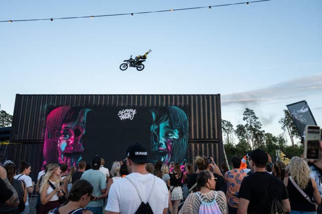 A Flic Flac rider jumps over two shipping containers during a freestyle motocross show at the Glücksgefühle Festival at the Hockenheimring in Hockenheim, Baden-Württemberg, Germany