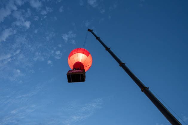 A Postcode Lottery balloon is hoisted into the air by a mobile crane at the Glücksgefühle Festival at the Hockenheimring in Hockenheim, Baden-Württemberg, Germany