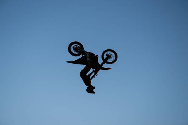 A Flic Flac rider jumps over a ramp during a freestyle motocross show at the Glücksgefühle Festival at the Hockenheimring in Hockenheim, Baden-Württemberg, Germany
