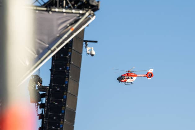 A Luftrettung rescue helicopter flies onto the festival grounds at the Glücksgefühle Festival at the Hockenheimring in Hockenheim, Baden-Württemberg, Germany
