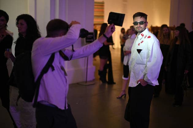 A photographer uses a LED light source to take a picture of a guest during Ukrainian Fashion Week SS27 at the Mystetskyi Arsenal National Cultural, Art and Museum Complex, Kyiv, Ukraine, September 5, 2026. (Photo by Yevhen Kotenko Ukrinform) Guests visit Ukrainian Fashion Week SS27 in Kyiv  Copyright: xYevhenxKotenkox