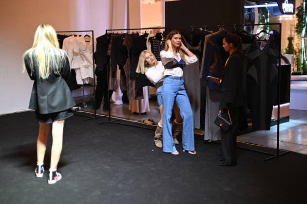 A woman tries on a garment during Ukrainian Fashion Week SS27 at the Mystetskyi Arsenal National Cultural, Art and Museum Complex, Kyiv, Ukraine, September 5, 2026. (Photo by Yevhen Kotenko Ukrinform) Guests visit Ukrainian Fashion Week SS27 in Kyiv  Copyright: xYevhenxKotenkox