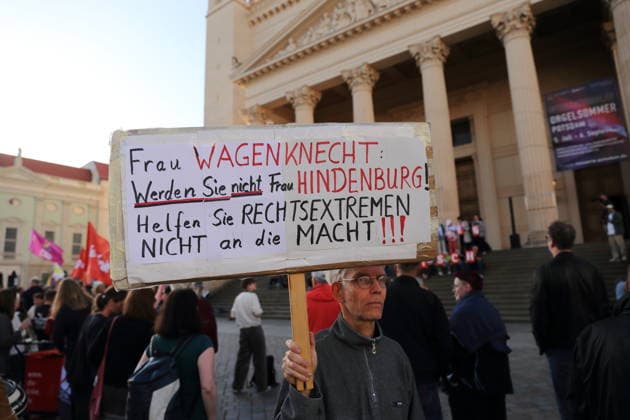 A protester holding a sign reading Ms. Wagenknecht, don’t become Ms. Hindenburg—don’t help the far right come to power during a rally against the Alternative for Germany (AfD) party following its victory in the state election in Saxony-Anhalt, Alter Markt, Potsdam, September 7, 2026. Rally against the AfD in Potsdam