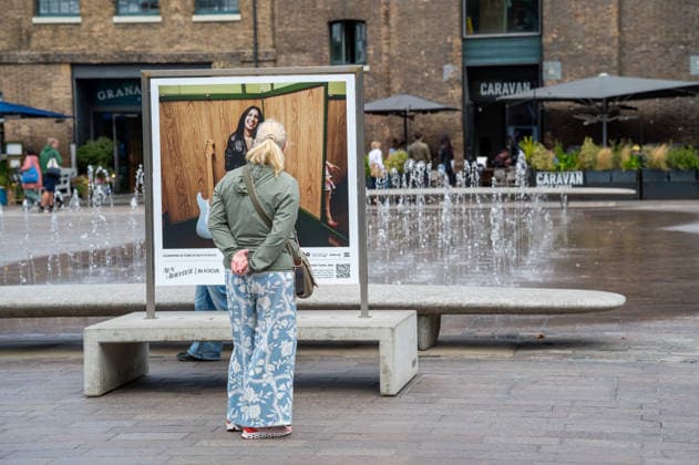 September 9, 2026, London, United Kingdom: A visitor seen looking at a portrait of Amy Winehouse displayed as part of the ˜Amy Winehouse. Visitors view ˜Amy Winehouse: In Focus™, a free outdoor photography exhibition at Granary Square and King™s Boulevard in King™s Cross, London. The exhibition features defining and previously unseen photographs of the late singer, offering an intimate portrait of her life and career and marking 20 years since the release of her acclaimed album ˜Back to Black™. The exhibition runs from 1 September to 15 October 2026. London United Kingdom - ZUMAs197 20260909_aaa_s197_582 Copyright: xJamesxWilloughbyx