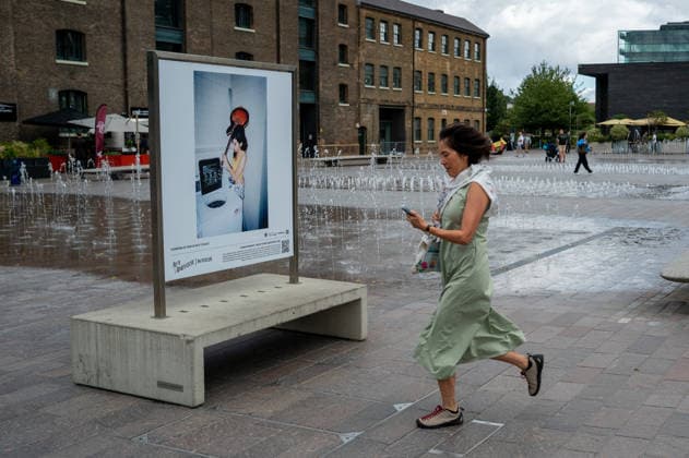 September 9, 2026, London, United Kingdom: A woman seen walking past a portrait of Amy Winehouse displayed as part of the ˜Amy Winehouse. Visitors view ˜Amy Winehouse: In Focus™, a free outdoor photography exhibition at Granary Square and King™s Boulevard in King™s Cross, London. The exhibition features defining and previously unseen photographs of the late singer, offering an intimate portrait of her life and career and marking 20 years since the release of her acclaimed album ˜Back to Black™. The exhibition runs from 1 September to 15 October 2026. London United Kingdom - ZUMAs197 20260909_aaa_s197_585 Copyright: xJamesxWilloughbyx
