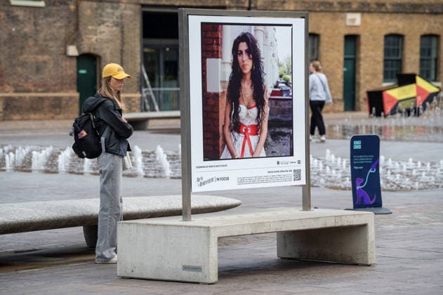 September 9, 2026, London, United Kingdom: A visitor seen standing near one of the portrait of Amy Winehouse displayed as part of the ˜Amy Winehouse. Visitors view ˜Amy Winehouse: In Focus™, a free outdoor photography exhibition at Granary Square and King™s Boulevard in King™s Cross, London. The exhibition features defining and previously unseen photographs of the late singer, offering an intimate portrait of her life and career and marking 20 years since the release of her acclaimed album ˜Back to Black™. The exhibition runs from 1 September to 15 October 2026. London United Kingdom - ZUMAs197 20260909_aaa_s197_584 Copyright: xJamesxWilloughbyx