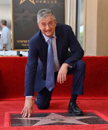 American screenwriter, television producer and director Greg Daniels kneels next to his star during an unveiling ceremony honoring Daniels with the 2,856th star on the Hollywood Walk of Fame in Los Angeles on Thursday, September 10, 2026.  LAP2026091010 JIMxRUYMEN