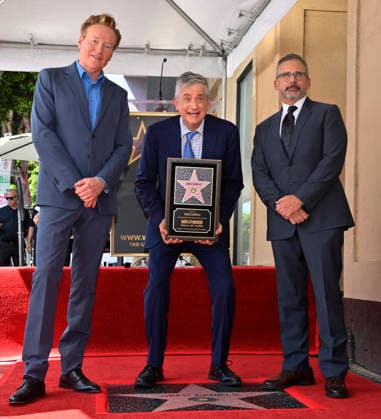 American screenwriter, television producer and director Greg Daniels holds a replica plaque as Conan O Brien (L) and Steve Carell look on during an unveiling ceremony honoring Daniels with the 2,856th star on the Hollywood Walk of Fame in Los Angeles on Thursday, September 10, 2026.  LAP2026091017 JIMxRUYMEN