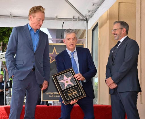 American screenwriter, television producer and director Greg Daniels holds a replica plaque as Conan O Brien (L) and Steve Carell look on during an unveiling ceremony honoring Daniels with the 2,856th star on the Hollywood Walk of Fame in Los Angeles on Thursday, September 10, 2026.  LAP2026091018 JIMxRUYMEN