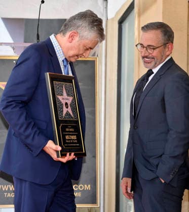 American screenwriter, television producer and director Greg Daniels holds a replica plaque as Steve Carell looks on during an unveiling ceremony honoring Daniels with the 2,856th star on the Hollywood Walk of Fame in Los Angeles on Thursday, September 10, 2026.  LAP2026091023 JIMxRUYMEN