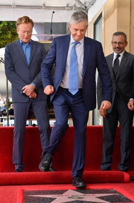American screenwriter, television producer and director Greg Daniels steps on his star as Conan O Brien (L) and Steve Carell look on during an unveiling ceremony honoring Daniels with the 2,856th star on the Hollywood Walk of Fame in Los Angeles on Thursday, September 10, 2026.  LAP2026091015 JIMxRUYMEN