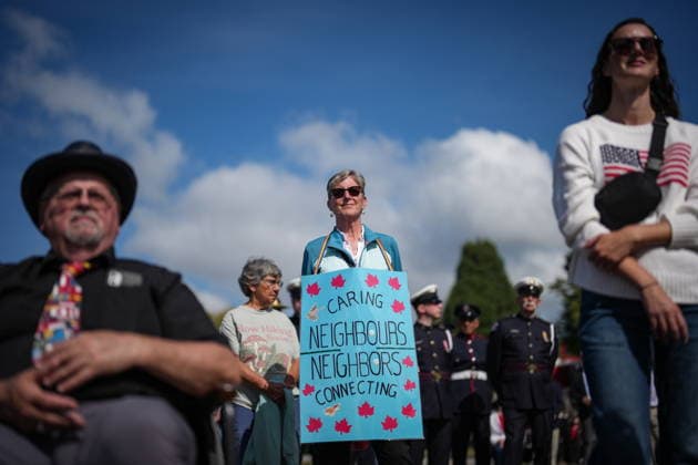 September 11, 2026, Surrey, Bc, CANADA: A woman wears a sign while attending the Northwest 9 11 Memorial ceremony at the Peach Arch monument on the Canada-U.S. border between Surrey, B.C., and Blaine, Wash., in Surrey, B.C., on Friday, Sept. 11, 2026. Surrey CANADA - ZUMAc35_ 20260911_zaf_c35_100 Copyright: xDarrylxDyckx