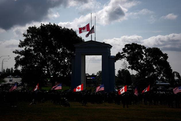 September 11, 2026, Surrey, Bc, CANADA: Canadian and U.S. flags fly as the Peach Arch monument is silhouetted during the Northwest 9 11 Memorial ceremony on the Canada-U.S. border between Surrey, B.C., and Blaine, Wash., in Surrey, B.C., on Friday, Sept. 11, 2026. Surrey CANADA - ZUMAc35_ 20260911_zaf_c35_132 Copyright: xDarrylxDyckx