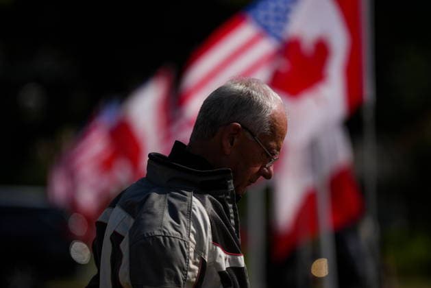 September 11, 2026, Surrey, Bc, CANADA: Canadian and U.S. flags fly in the wind as a man listens during the Northwest 9 11 Memorial ceremony at the Peach Arch monument on the Canada-U.S. border between Surrey, B.C., and Blaine, Wash., in Surrey, B.C., on Friday, Sept. 11, 2026. Surrey CANADA - ZUMAc35_ 20260911_zaf_c35_136 Copyright: xDarrylxDyckx
